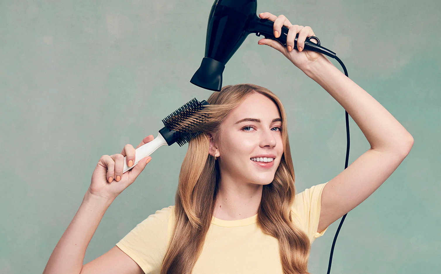 blow drying hair with a round brush