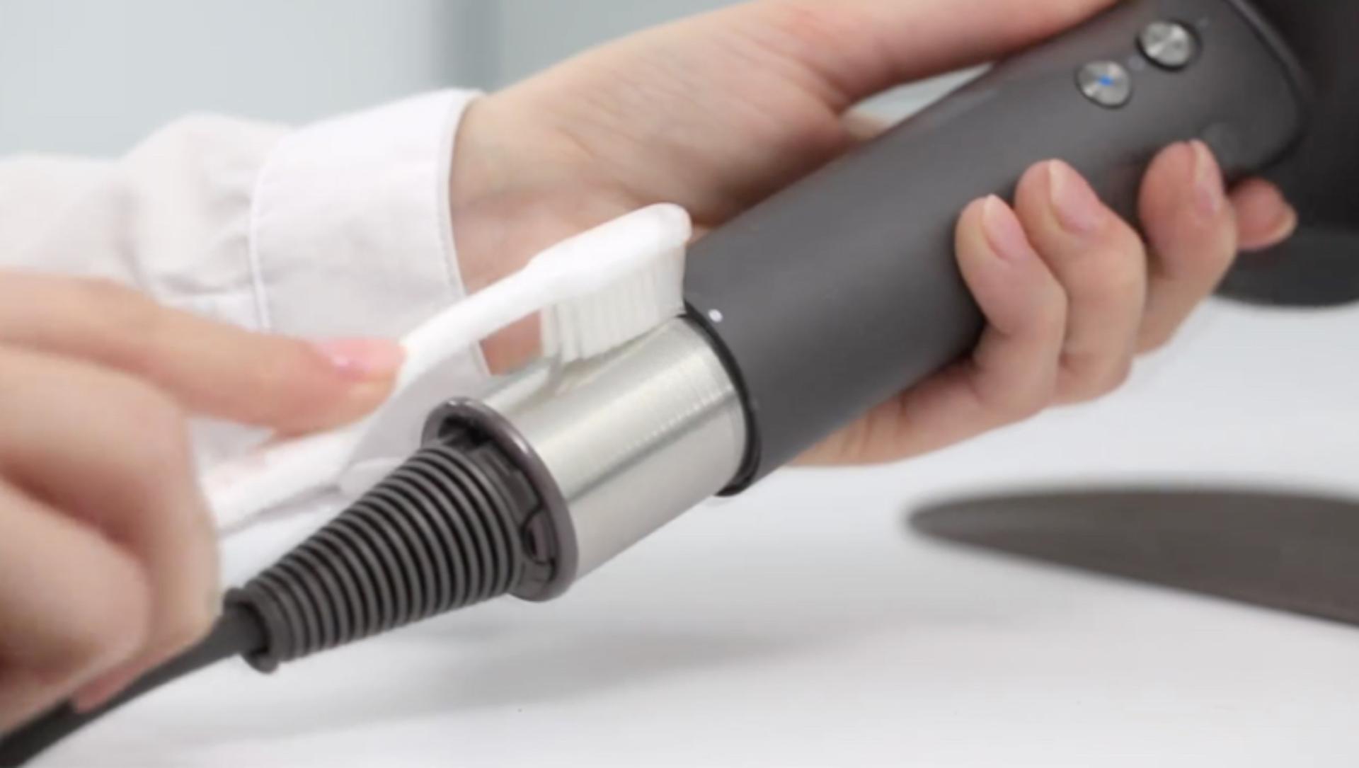 cleaning a hairdryer filter with a toothbrush