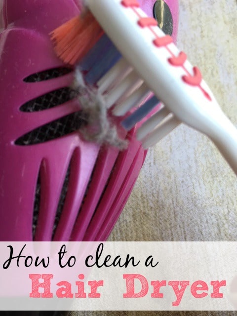 Cleaning lint from hair dryer filter with toothbrush