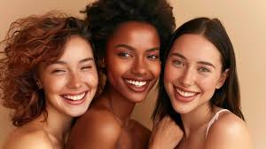 Three women with different hair types smiling together.