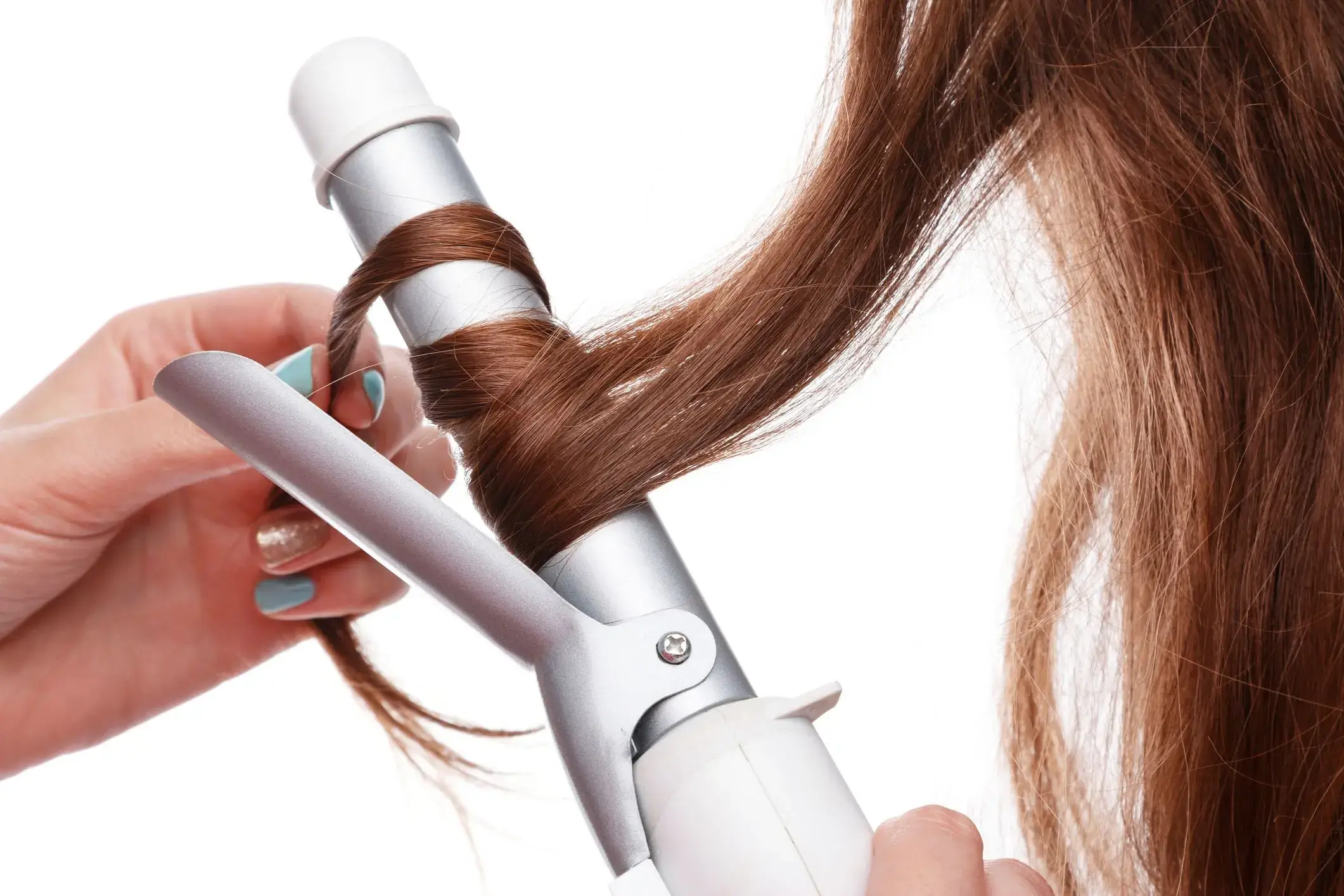 Close-up of hair being curled with a curling iron.