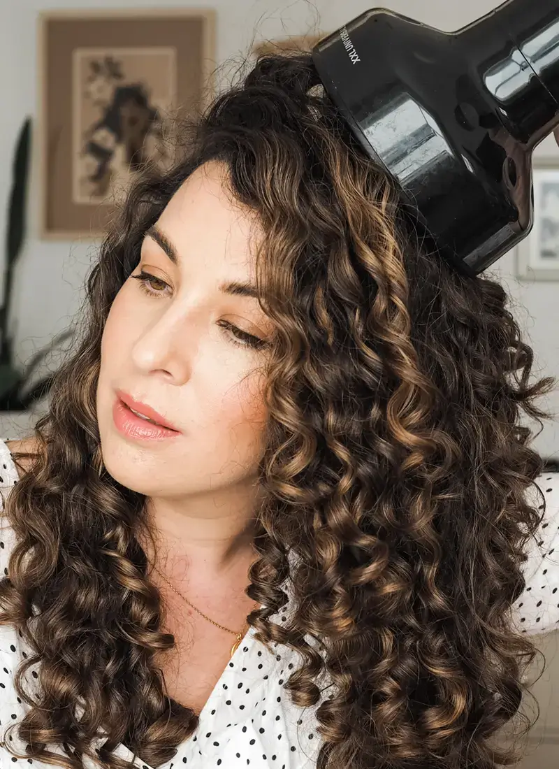Voluminous curls being dried with a diffuser attachment.