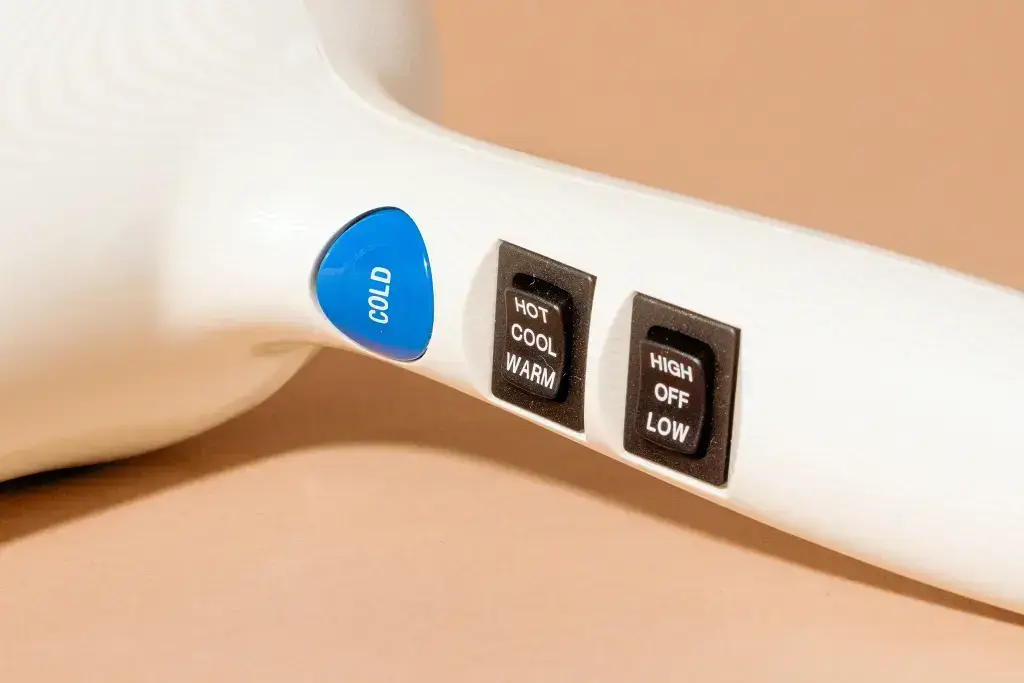 Hair dryer with temperature and speed control buttons.