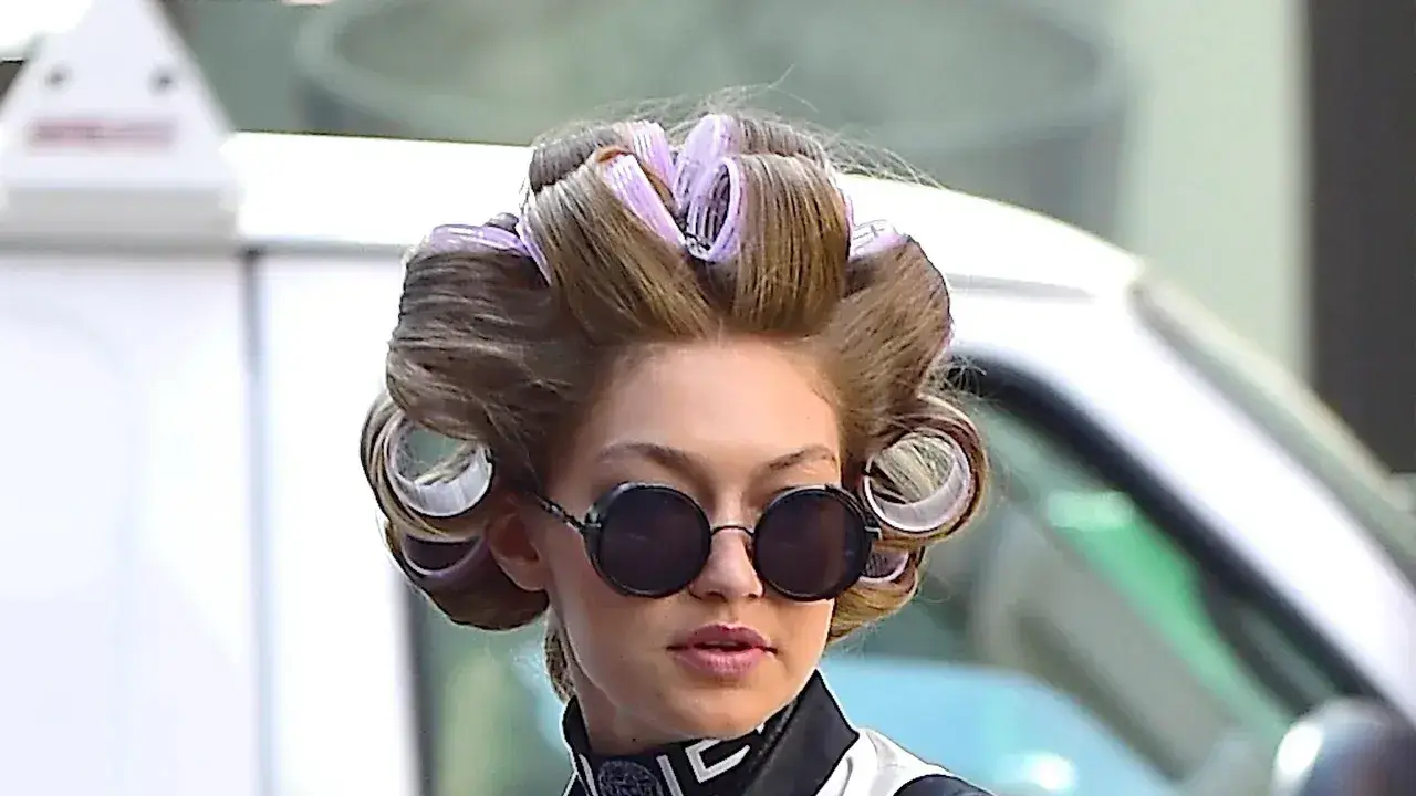 Woman with hair in rollers, wearing sunglasses