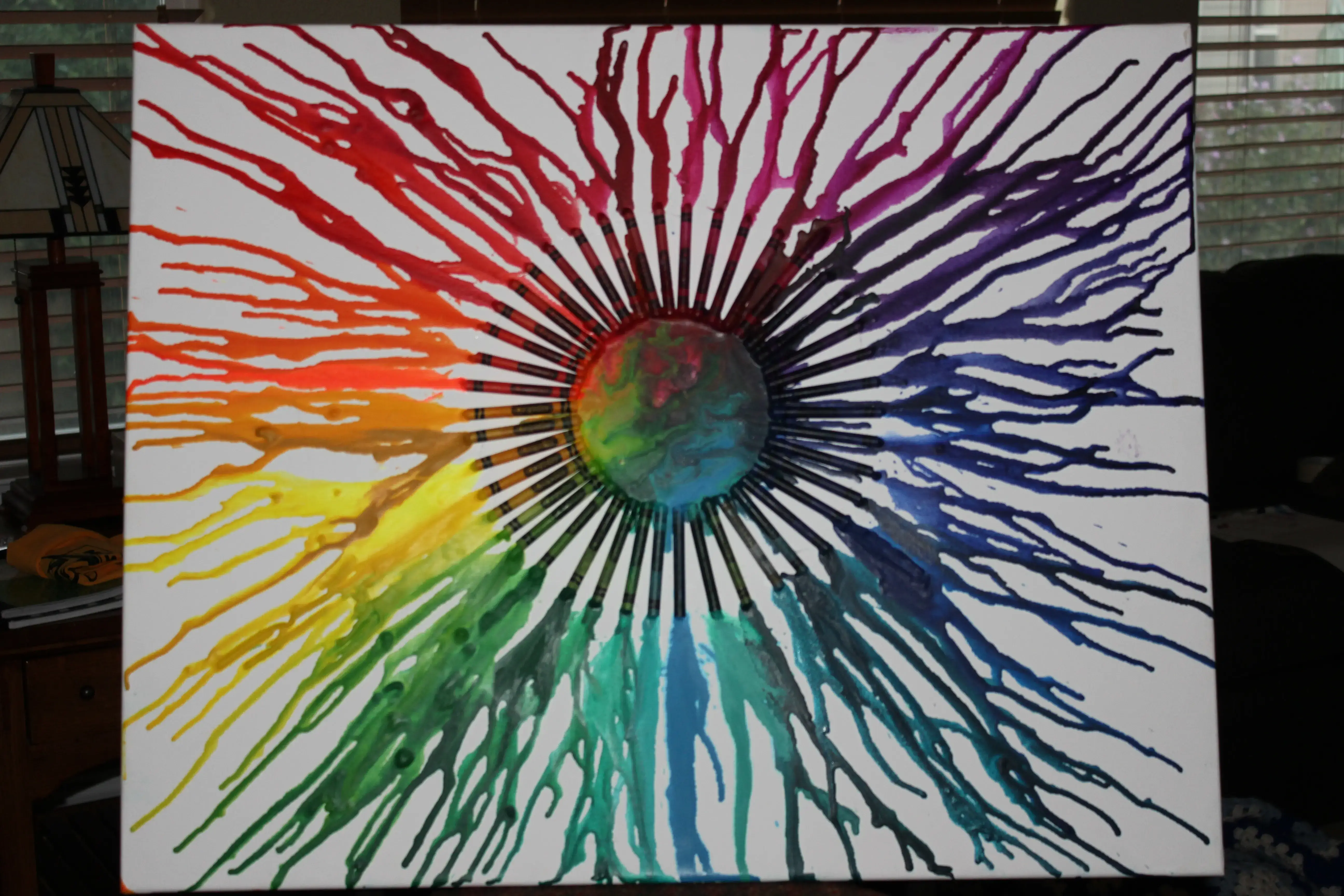 Melting crayons into art with a hairdryer on canvas.