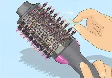 Illustrated guide to cleaning a brush hair dryer.