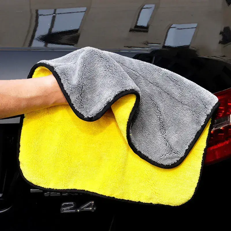Microfiber cloth over a hand, polishing a car.