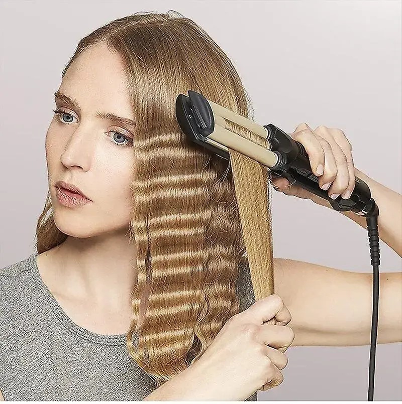 Woman using a crimping iron on her straight hair.